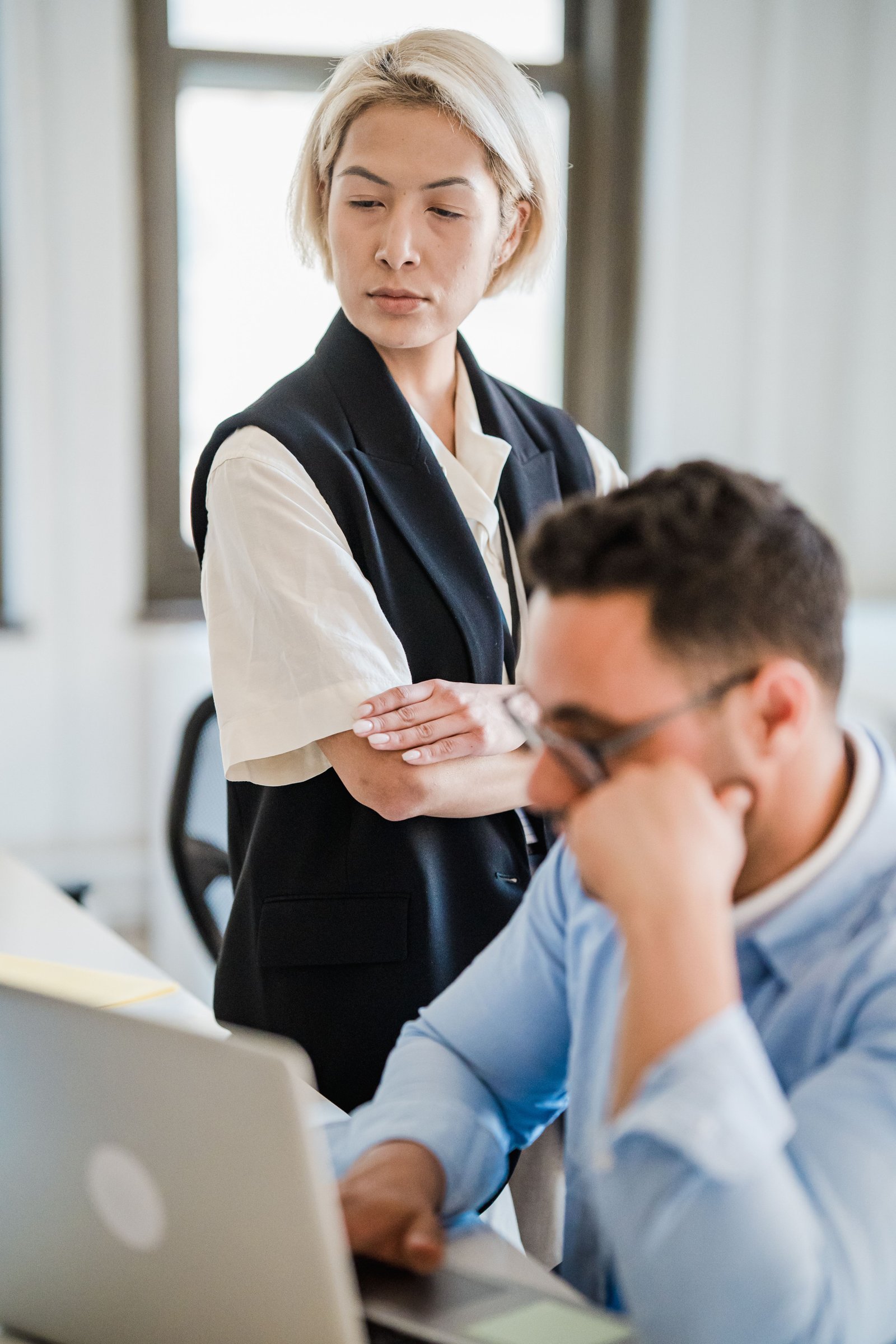 Focused business professionals collaborating in a modern office setting with a digital workspace.