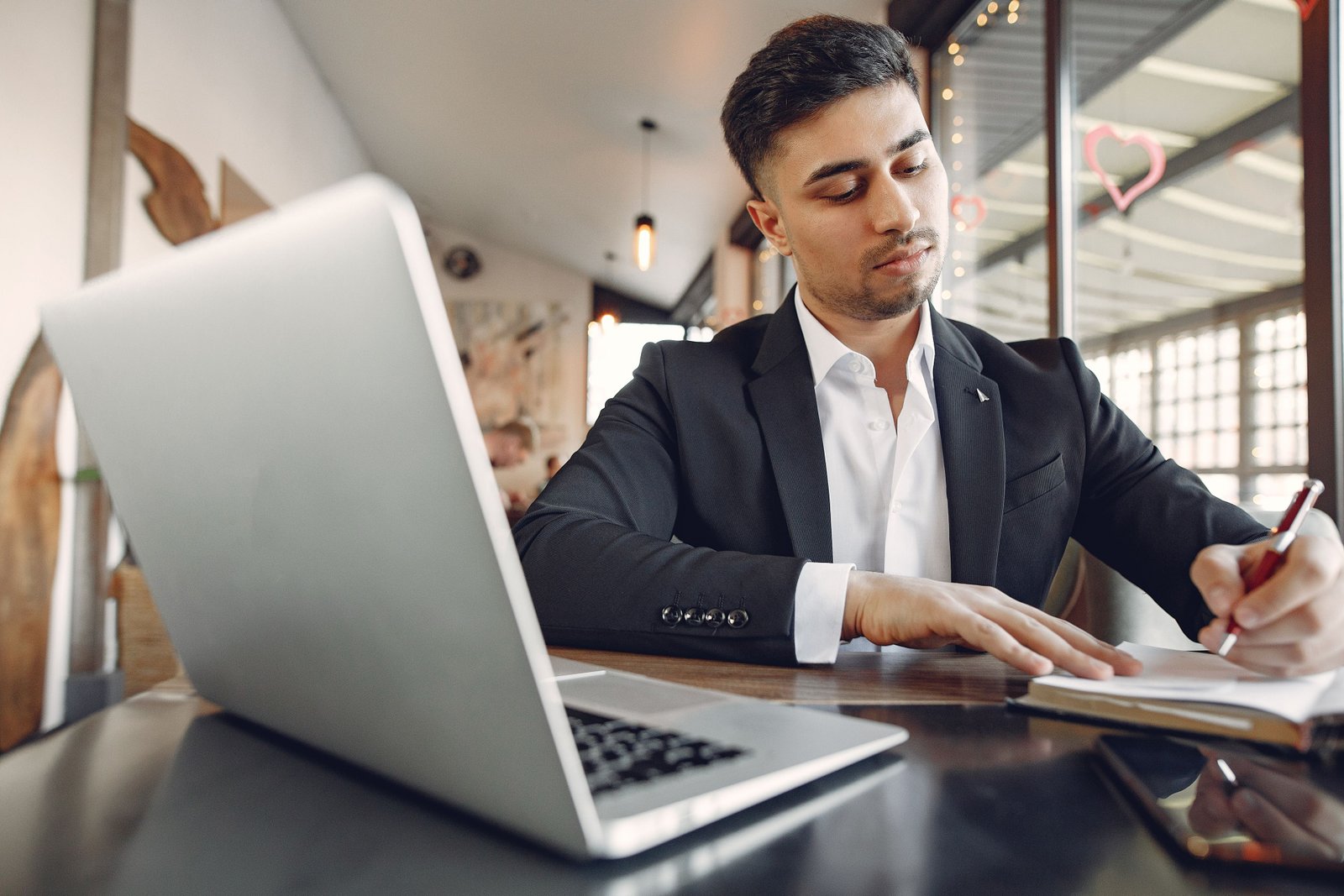 Young entrepreneur focused on work in a contemporary office setting.