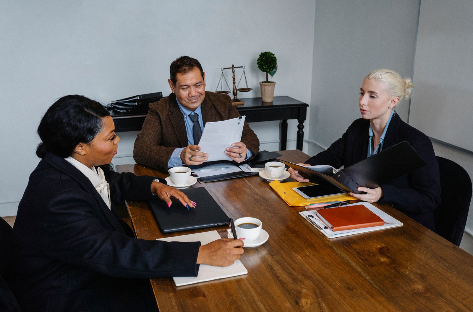 A diverse group of professionals discussing business strategies in an office setting.